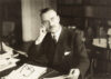 Thomas Mann, sitting at his desk.